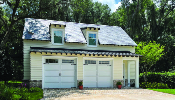 Two white Overhead Door Courtyard carriage house garage doors on a detached garage